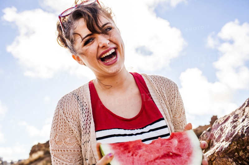 Caucasian woman eating watermelon outdoors