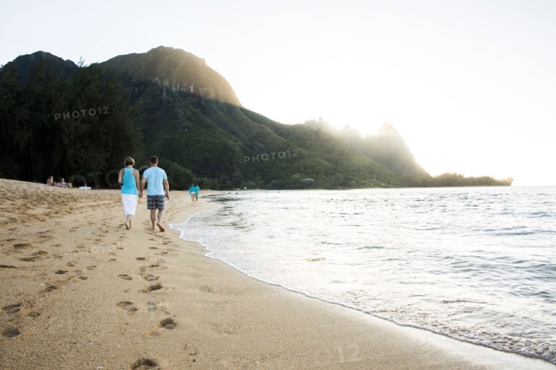 Couple walking together near ocean on beach