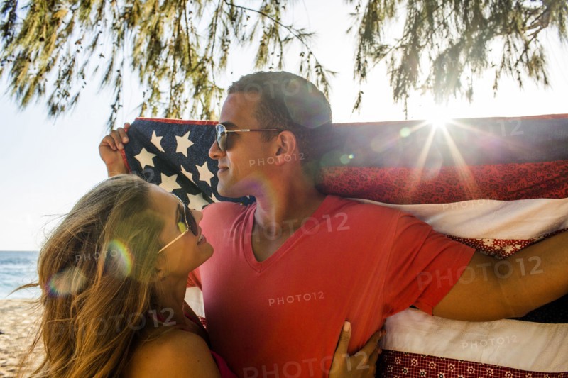 Couple holding American flag quilt