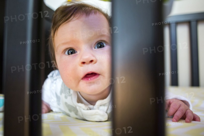 Close up of Caucasian baby girl laying in crib