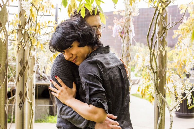 Smiling couple hugging in park
