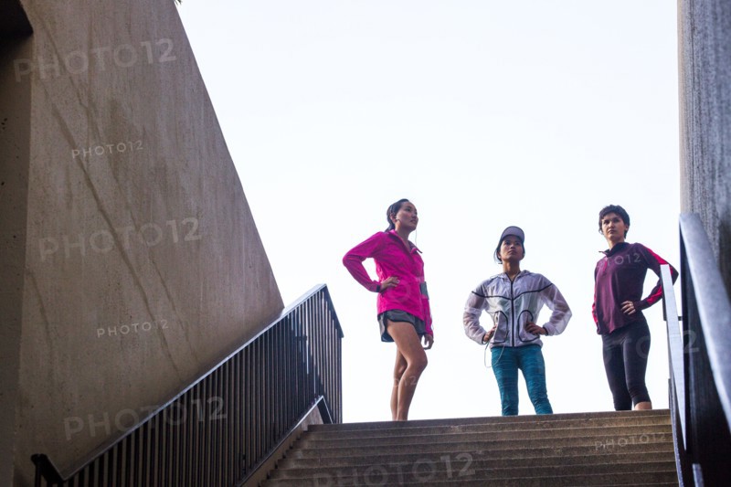 Runners standing at top of urban staircase