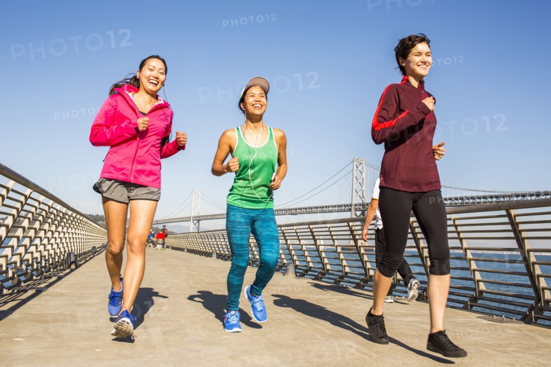 Women running on urban footbridge