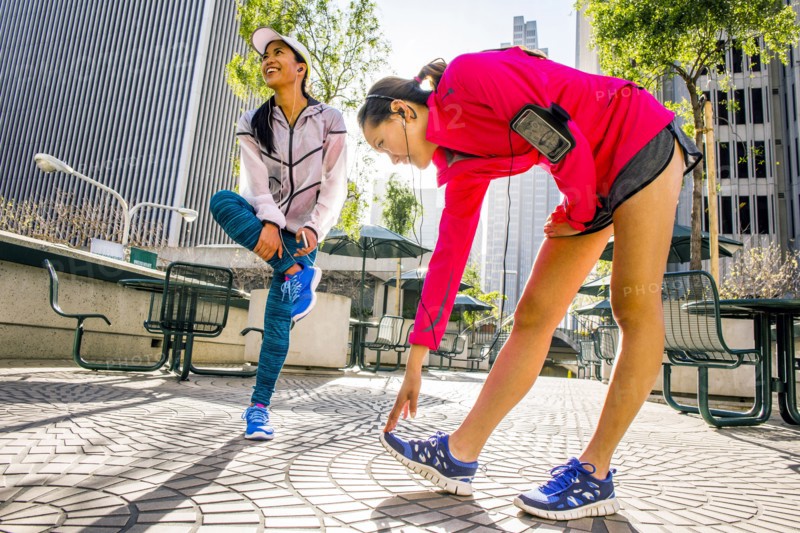 Runners stretching in urban park