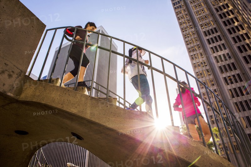 Low angle view of women running on urban staircase