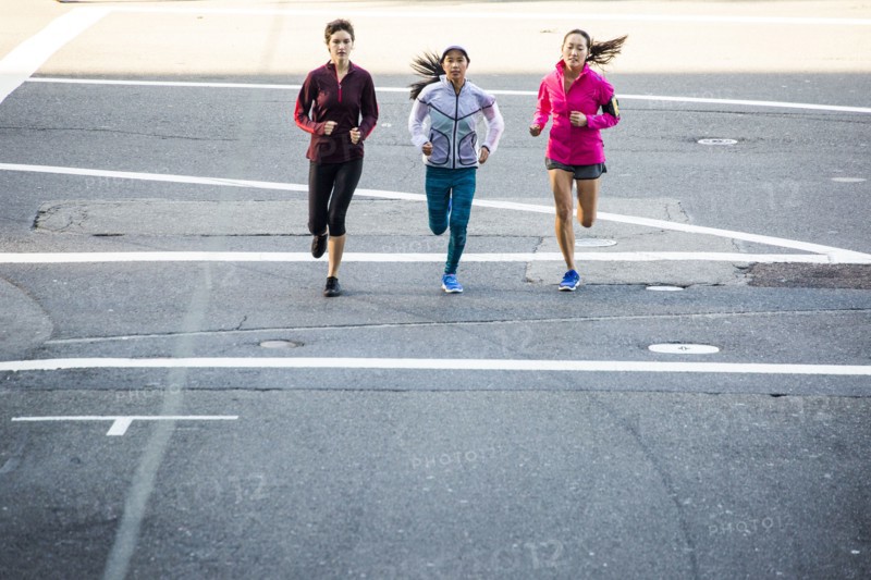 High angle view of women running in city street