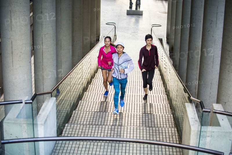 High angle view of women running on staircase