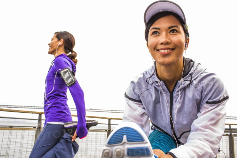 Runners stretching at waterfront