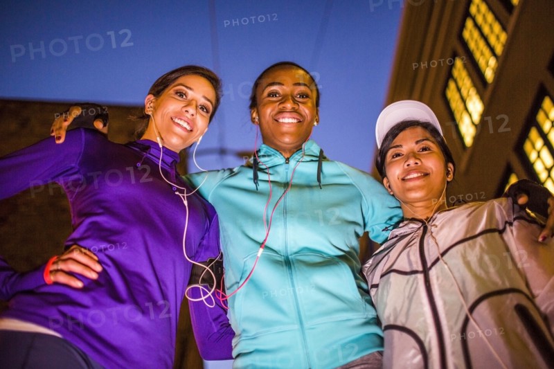 Low angle view of runners smiling at night