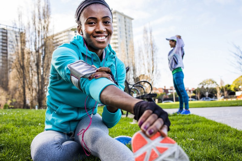 Runner stretching in urban park