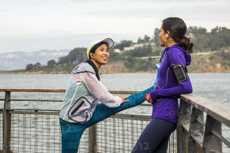 Runners stretching at waterfront