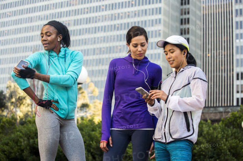 Runners using cell phone near high rise buildings