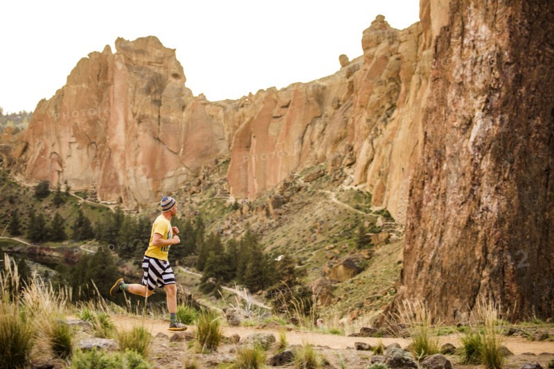 Caucasian man running near desert hills