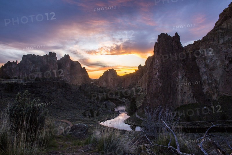 Creek reflecting sunset sky in desert landscape