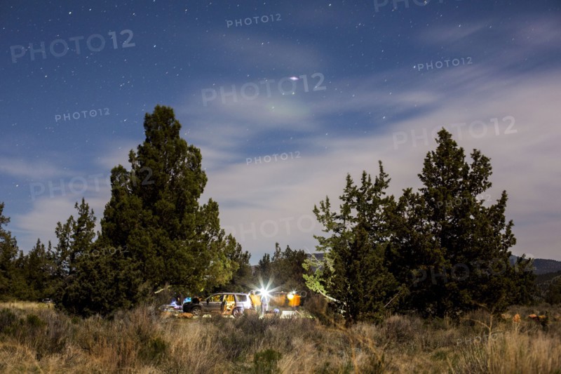 Campsite in remote field under cloudy sky