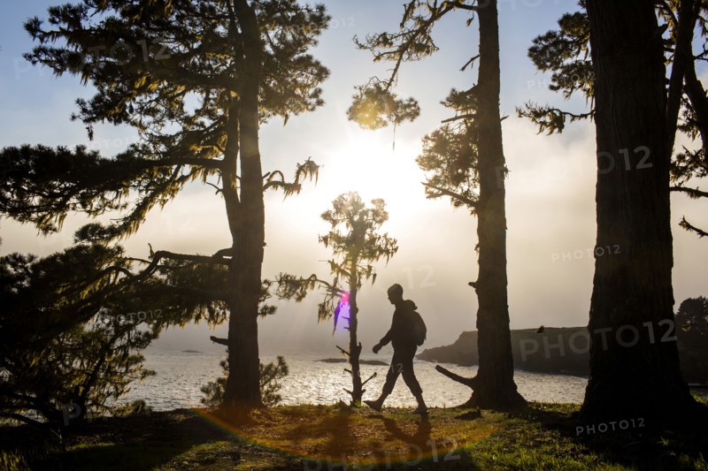 Caucasian hiker walking near ocean