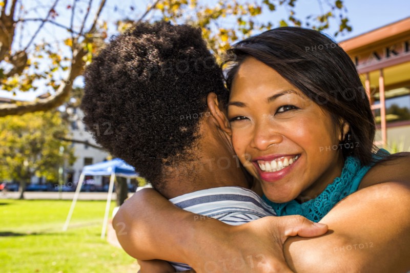 Smiling couple hugging in park