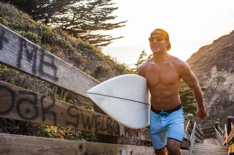 Caucasian surfer carrying surfboard