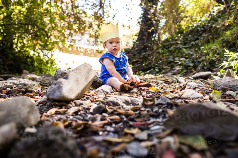 Caucasian baby girl sitting in grass