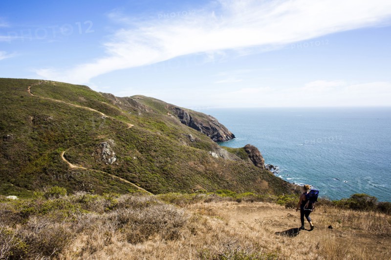 Caucasian mother and child hiking at coast