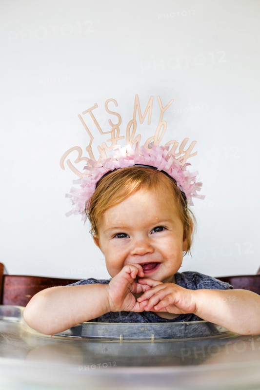 Caucasian baby girl wearing birthday crown