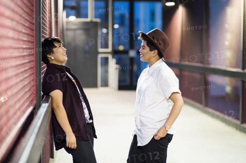 Asian couple talking in hallway