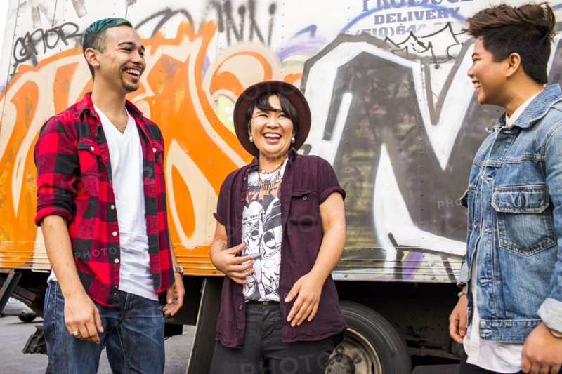 Friends laughing at graffiti wall