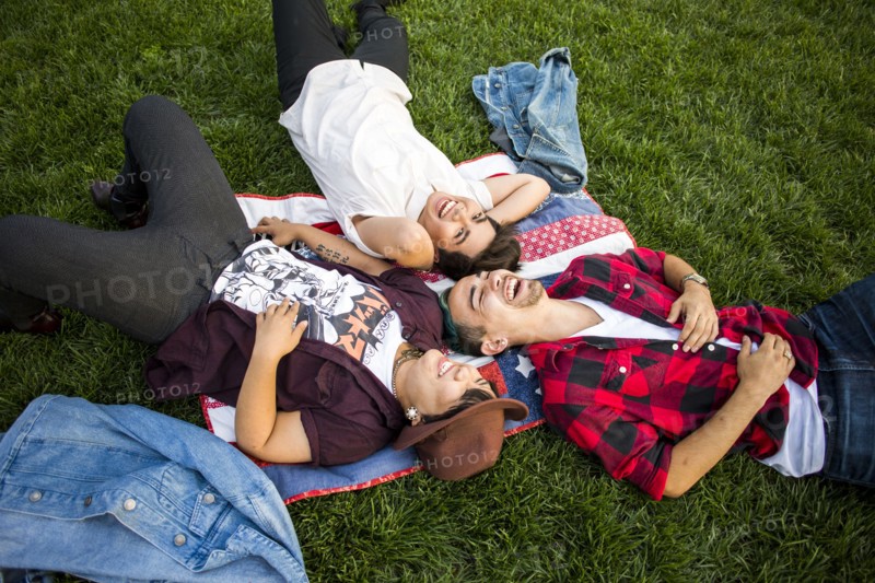 Friends laying in grass