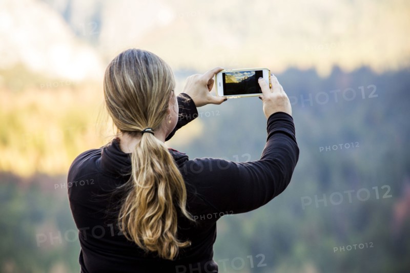 Caucasian woman photographing Yosemite National Park