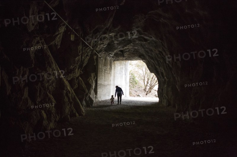 Caucasian mother and daughter walking in cave