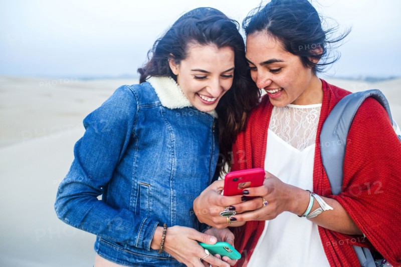 Mixed race women using cell phones