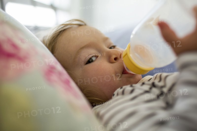 Caucasian baby girl drinking from bottle
