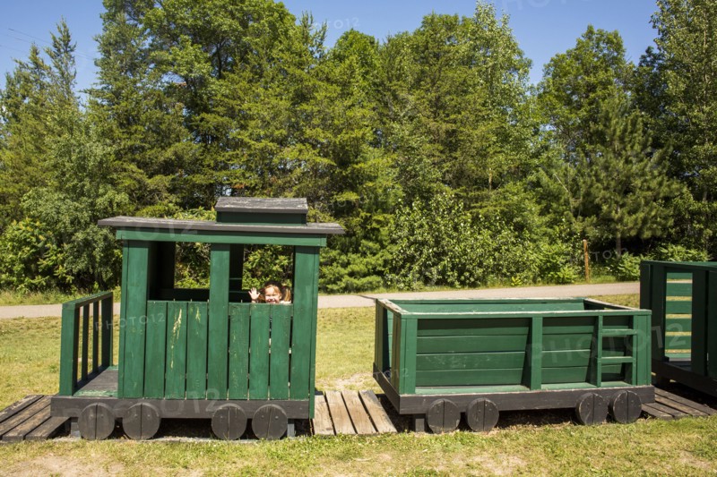 Caucasian baby girl waving on playground train