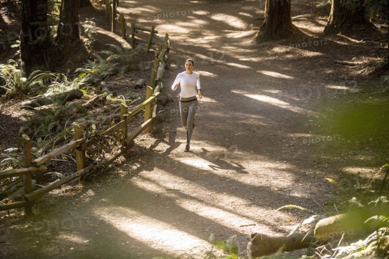 Woman running on forest path