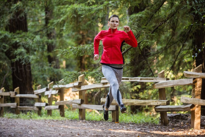 Woman running on forest path