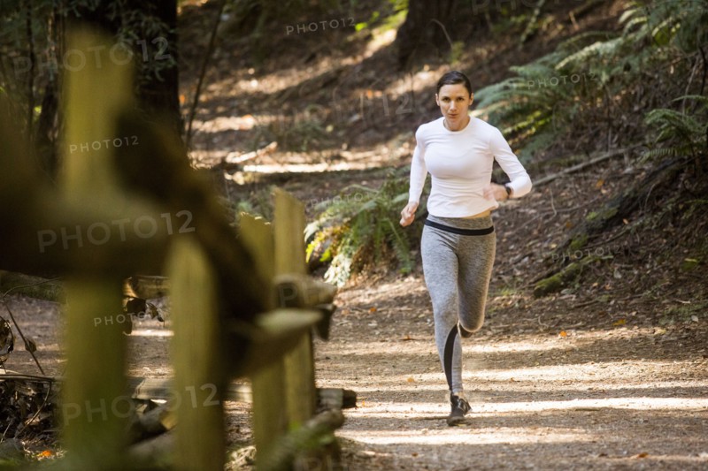Woman running on forest path