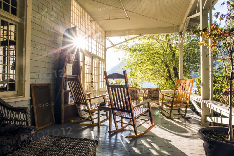 Reflection of sun on porch with rocking chairs