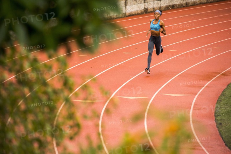 Black woman running on track
