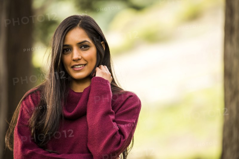 Portrait of smiling Indian woman wearing sweater