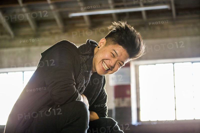 Portrait of laughing androgynous Asian man