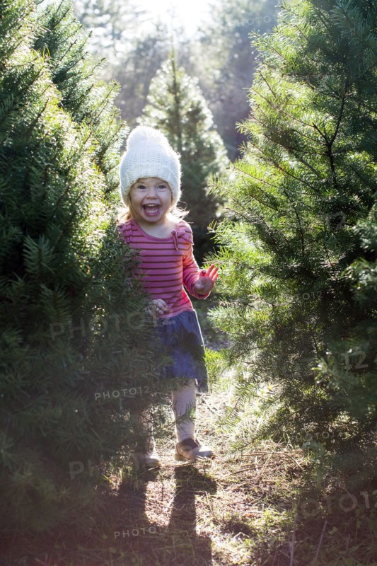 Excited Caucasian girl standing near trees