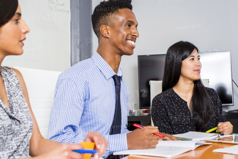 People smiling in business meeting
