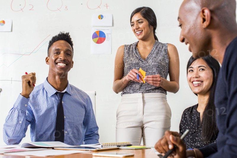 People laughing in business meeting