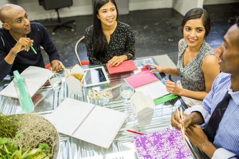 People eating with chopsticks in meeting