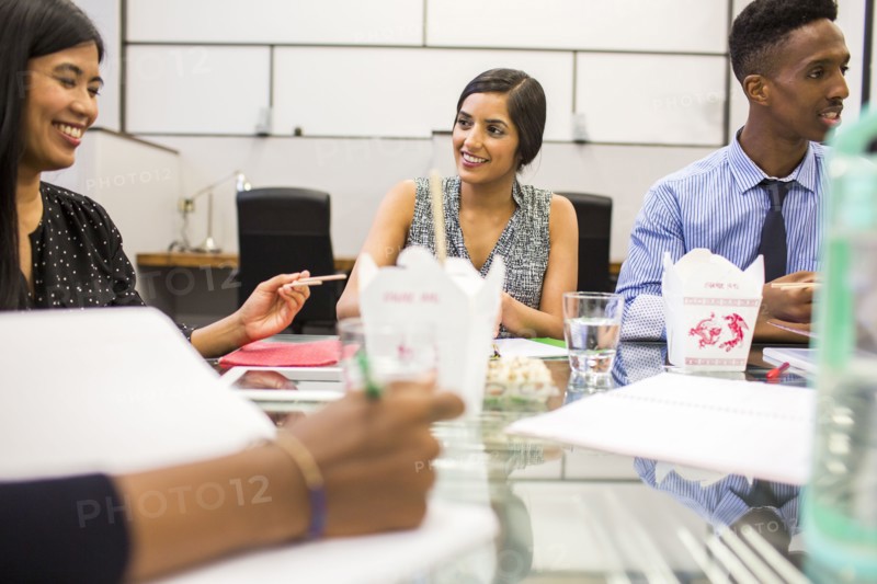 People eating with chopsticks in meeting