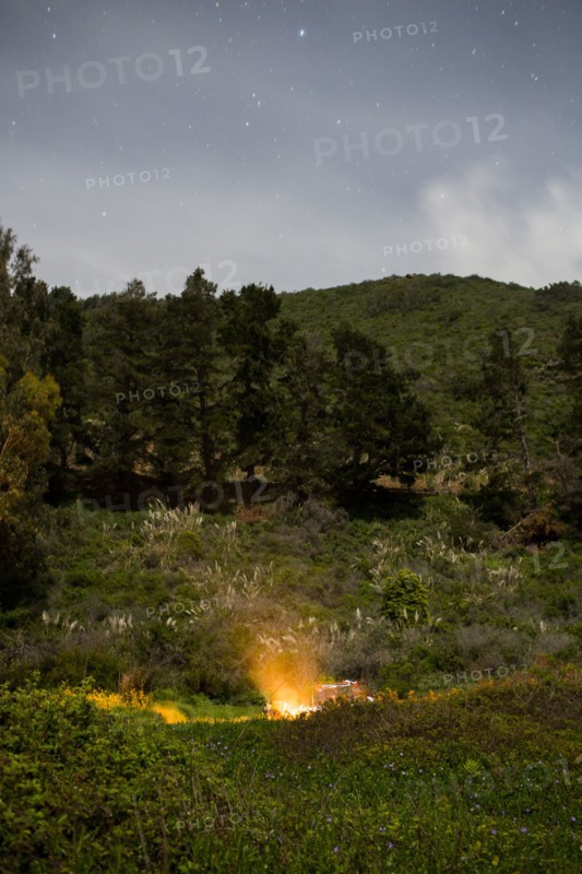 Campfire on hill at night