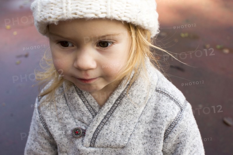 Close up of Caucasian girl wearing sweater and hat