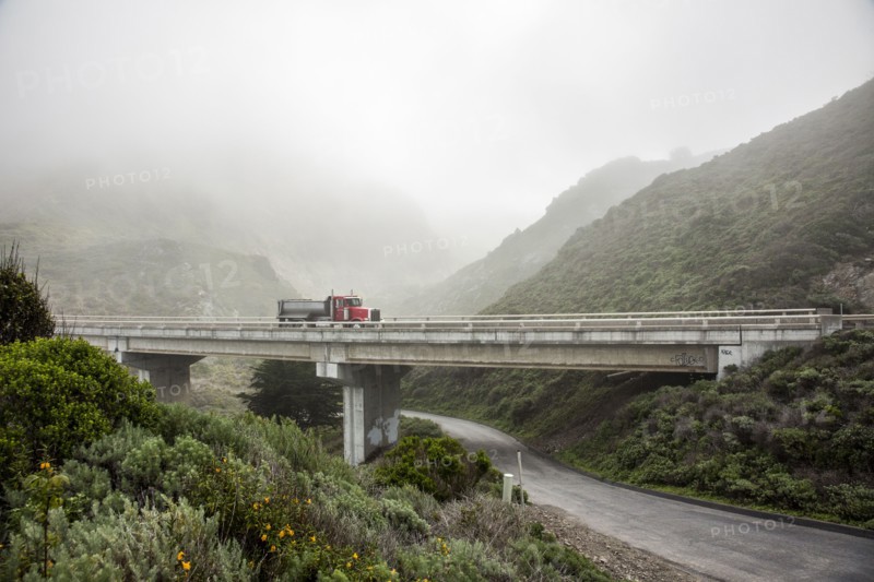 Truck driving on overpass in hills