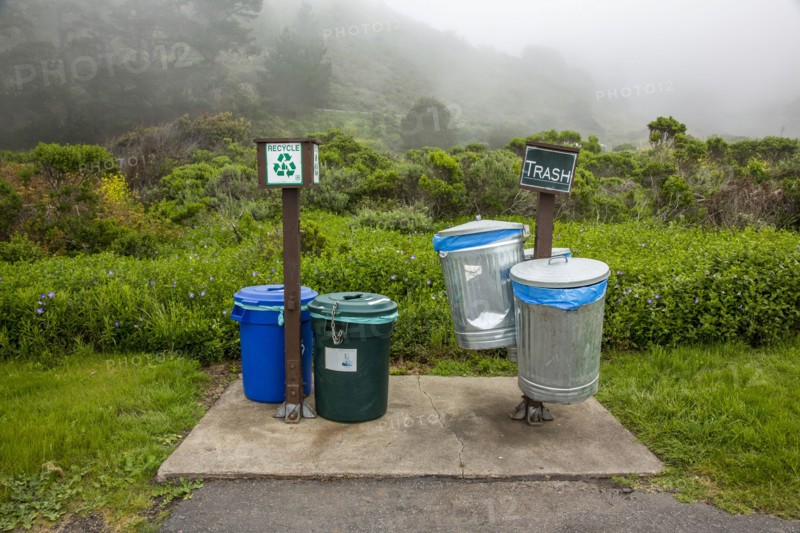Trash and recycling bins in park