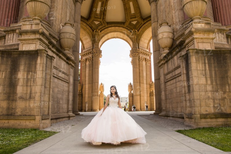 Smiling Hispanic girl wearing gown